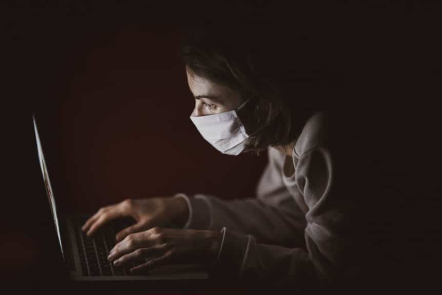 Women wearing face mask on computer